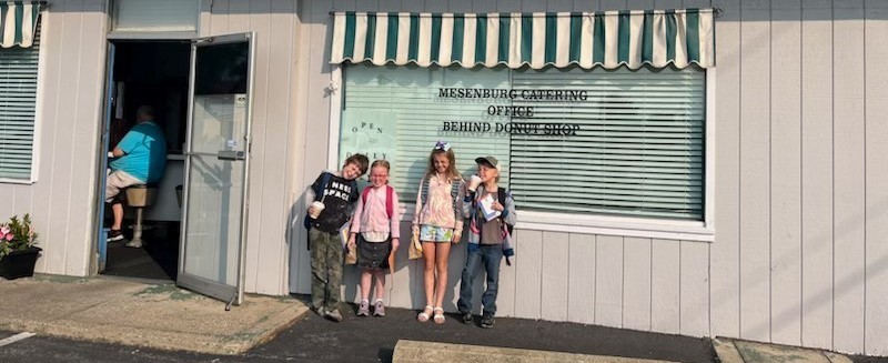 Students standing in front of the Donut Shop