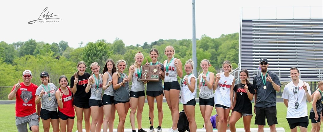 Girls track team with trophies
