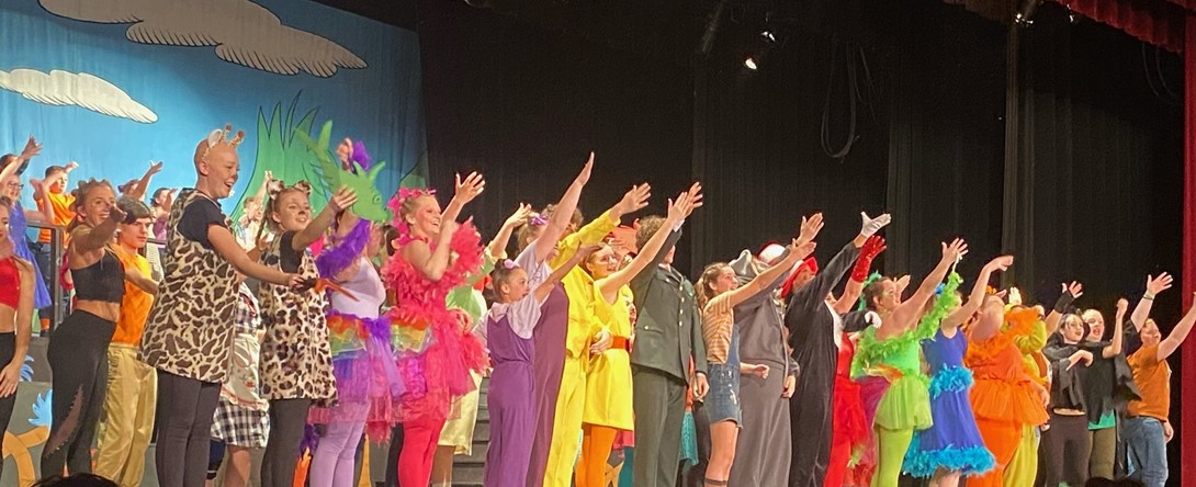 Students part of the musical waving 